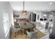 Virtually staged dining area with a modern table and chairs, adjacent to the kitchen at 8969 Sheppard Dr, Lake Wales, FL 33898