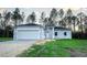 Newly constructed one-story home with a two-car garage and a spacious lawn at 8969 Sheppard Dr, Lake Wales, FL 33898
