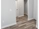 Hallway with neutral walls, wood-look flooring, and access to other rooms at 8969 Sheppard Dr, Lake Wales, FL 33898