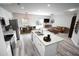 Virtually staged kitchen with modern island and stainless steel appliances at 8969 Sheppard Dr, Lake Wales, FL 33898