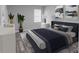 Virtually staged main bedroom with a king-size bed, neutral color palette, and modern decor at 8969 Sheppard Dr, Lake Wales, FL 33898