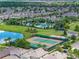 Aerial view of community with pool, tennis court, and homes at 9849 Lost Creek Dr, Winter Garden, FL 34787
