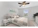 Guest bedroom with a queen-size bed, nightstand and window at 9849 Lost Creek Dr, Winter Garden, FL 34787