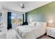 Main bedroom with green accent wall, comfortable bed and ample natural light at 9849 Lost Creek Dr, Winter Garden, FL 34787
