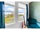 Bedroom with lake view, guitar, and comfy teal chair at 9849 Lost Creek Dr, Winter Garden, FL 34787