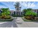 Community entrance with palm trees and landscaping at 9849 Lost Creek Dr, Winter Garden, FL 34787