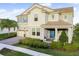Two-story house with light beige siding, blue shutters, and a landscaped front yard at 9849 Lost Creek Dr, Winter Garden, FL 34787
