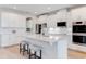Modern kitchen with white cabinets, quartz countertops, and stainless steel appliances at 9849 Lost Creek Dr, Winter Garden, FL 34787