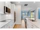 Modern kitchen with white cabinets, quartz countertops, and stainless steel appliances at 9849 Lost Creek Dr, Winter Garden, FL 34787