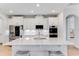 Modern kitchen with white cabinets, quartz countertops, and stainless steel appliances at 9849 Lost Creek Dr, Winter Garden, FL 34787