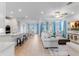 Bright living room with hardwood floors, light-colored furniture, and large windows at 9849 Lost Creek Dr, Winter Garden, FL 34787