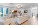 Comfortable living room with light-colored sofa and armchairs, and large TV at 9849 Lost Creek Dr, Winter Garden, FL 34787
