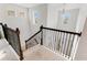 Elegant staircase with dark wood railings and carpeted steps at 9849 Lost Creek Dr, Winter Garden, FL 34787