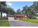 Brick home with a long driveway and a two-car garage at 10150 Sw 73Rd Ter, Ocala, FL 34476