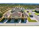 Aerial view of townhouses and surrounding landscape at 141 Holly Village Dr, Davenport, FL 33837