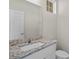 Bathroom with granite countertop, single sink, and toilet at 141 Holly Village Dr, Davenport, FL 33837