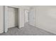 Bedroom with grey carpet, closet, and access to hallway at 141 Holly Village Dr, Davenport, FL 33837
