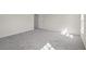 Bright bedroom featuring grey carpet and a window at 141 Holly Village Dr, Davenport, FL 33837