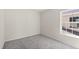 Spacious bedroom featuring grey carpet and a window at 141 Holly Village Dr, Davenport, FL 33837