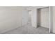 Bedroom with grey carpet, closet, and additional room access at 141 Holly Village Dr, Davenport, FL 33837