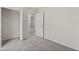 Bright bedroom with grey carpet, closet and door to another room at 141 Holly Village Dr, Davenport, FL 33837