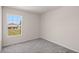 Bedroom with grey carpet and a window at 141 Holly Village Dr, Davenport, FL 33837