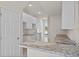 Modern kitchen with granite countertops and white cabinets at 141 Holly Village Dr, Davenport, FL 33837