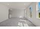 Open living area with grey carpet and access to backyard at 141 Holly Village Dr, Davenport, FL 33837