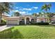 Two-story home with landscaping and driveway at 142 Heatherbrooke Cir, Oviedo, FL 32765