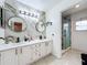 Modern bathroom with double sinks, marble accents, and a glass shower at 1725 Singing Palm Dr, Apopka, FL 32712