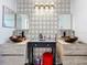 Bathroom boasts double sinks and stylish geometric wallpaper at 1725 Singing Palm Dr, Apopka, FL 32712