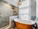 Luxurious bathroom featuring a freestanding tub and walk-in shower at 1725 Singing Palm Dr, Apopka, FL 32712