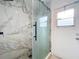 Updated bathroom with marble tile shower and glass enclosure at 1725 Singing Palm Dr, Apopka, FL 32712