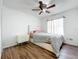 Bright bedroom with wood floors, ceiling fan, and double dresser at 1725 Singing Palm Dr, Apopka, FL 32712