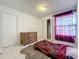 Cozy bedroom with wood-look floors and a double door closet at 1725 Singing Palm Dr, Apopka, FL 32712