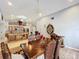 Formal dining room with wood table and chairs, open to kitchen at 1725 Singing Palm Dr, Apopka, FL 32712