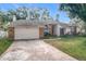 Charming single-story home with brick facade and attached garage at 1725 Singing Palm Dr, Apopka, FL 32712
