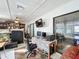 Spacious Florida room with work area, TV, and ample seating at 1725 Singing Palm Dr, Apopka, FL 32712