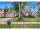 Single story home with a brick facade and mature landscaping at 1725 Singing Palm Dr, Apopka, FL 32712