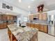 Spacious kitchen featuring granite countertops and ample cabinetry at 1725 Singing Palm Dr, Apopka, FL 32712