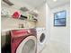 Bright laundry room, washer, dryer, and shelving for storage at 1725 Singing Palm Dr, Apopka, FL 32712
