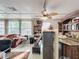 Living room with hardwood floors, built in bar, and large windows at 1725 Singing Palm Dr, Apopka, FL 32712