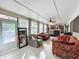 Bright sunroom with comfy seating and access to the backyard at 1725 Singing Palm Dr, Apopka, FL 32712
