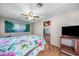 Bedroom with tropical wall art and ceiling fan at 3250 Mountain Lake Cutoff Rd, Lake Wales, FL 33859