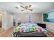 Bedroom with tropical wall art and ceiling fan at 3250 Mountain Lake Cutoff Rd, Lake Wales, FL 33859