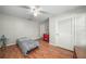 Bedroom with hardwood floors and louvered closet door at 3250 Mountain Lake Cutoff Rd, Lake Wales, FL 33859