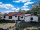 White house with red tile roof, landscaping, and stone pathway at 3250 Mountain Lake Cutoff Rd, Lake Wales, FL 33859