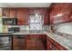 Kitchen features dark wood cabinets and a double sink at 3250 Mountain Lake Cutoff Rd, Lake Wales, FL 33859