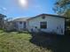 View of the side of a white single story home at 3250 Mountain Lake Cutoff Rd, Lake Wales, FL 33859