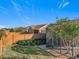 Private backyard with wooden fence, landscaping, and screened patio at 349 Alcove Dr, Groveland, FL 34736